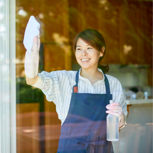 Express home cleaning service – professional cleaner wiping glass window